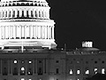 Black and white photo of U.S. Capitol at night.