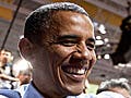 In a crowd, President Obama shakes hands.