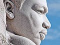 A sideview of a man's head, chiseled from stone.