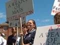 A photo of protestors with signs.