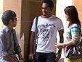 Four students having a discussion in a hallway.
