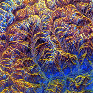 Colorful image of mountainous landscape taken from above.