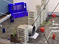 A photo of the 2009 competition table, with a row of skyscrapers dividing it into an area for each robot containing cans and bales of trash to be crushed and stacked in the appropriate target area.