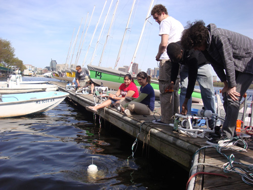 Students on the dock maneuver their robots around, make adjustments before launch, and watch each others' progress.