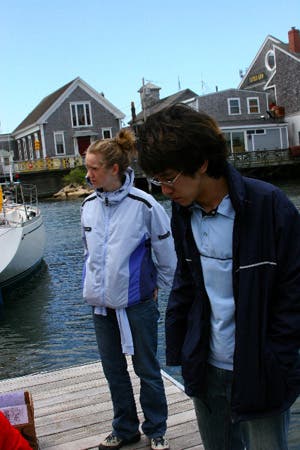 Two students standing on a dock.
