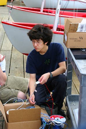 Student connecting two cables together.
