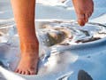 A pair of feet walking on fluid.