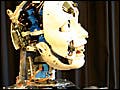 A humanoid robot moving waving its left arm.