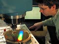 A technician works with a metrology device.