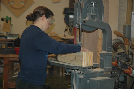 A student cuts a shear line.  Note the profile drawn in pencil on the side.