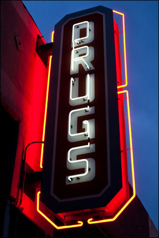 A neon sign that says "DRUGS".