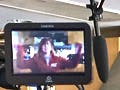 A woman in an MIT shirt being filmed by a crew.