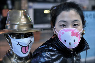 A photo of a girl with a medical face mask featuring a cat.