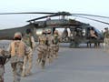 Iraqi soldiers board a Black Hawk helicopter.