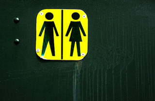 A sign for a unisex bathroom.