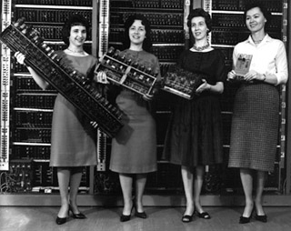 Photo of four women holding computer boards.