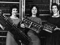 Photo of four women holding computer boards.