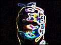 A human form stands in darkness, wearing a bodysuit illuminated from head to toe with various multi-colored circuits.