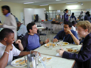 Students having a conversation in a cafeteria.