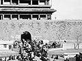 A black and white photo of a busy street scene in front of Hata-men gate, Beijing, China.