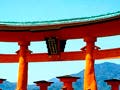 An oriental red wooden structure standing in a lake surrounding with mountains