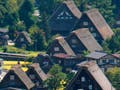 Clusters of steep-roofed houses in the countryside of fields