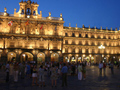 A photograph of the Plaza Mayor in Salamanca, Spain at dusk.