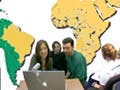 Classroom composite of Spanish students with a map of the world.