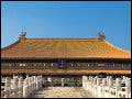 The steps leading up to the Hall of Supreme Harmony in the Forbidden City in Beijing, China. The stairs are separated in the center by a path of dragon carvings. The sky is very blue.