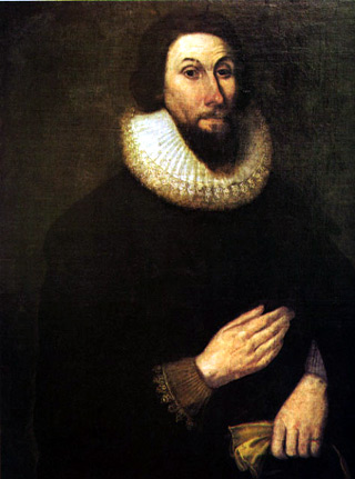 Oil painting of a middle-aged man with dark brown hair and beard, dressed in black with fine lace at the wrists and neck.