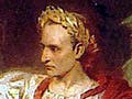 A seated man, wearing a laurel wreath and an elaborate toga, recoils from a group of men, one of whom has a dagger.