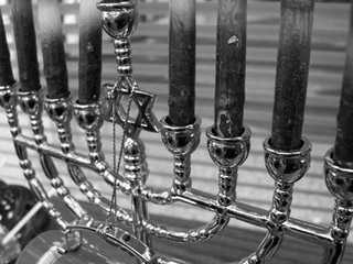 Black and white close-up photo of a menorah, the Star of David in its center.