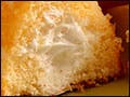 A plate of yellow sponge cakes filled with cream in the center.