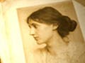 An illustration of a book in a spotlight, with portraits of William Shakespeare and Virginia Woolf on facing pages.