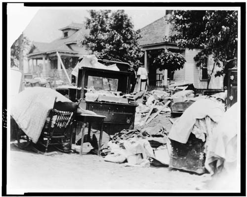 Furniture in street during race riot, probably due to eviction, Tulsa, Oklahoma, 1921.