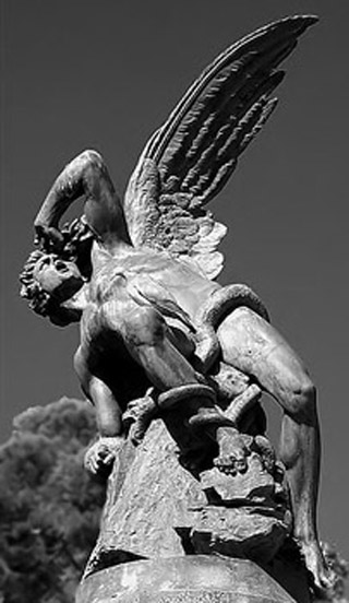 Black and white photo of the statue of an angel, having just fallen from the sky.