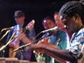 Photo of Lamine Toure performing on the sabar.