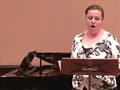 Woman singing with piano accompanist.