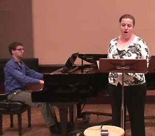 Woman singing with piano accompanist.