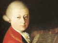 Painting of Wolfgang Amadeus Mozart sitting at a harpsichord.