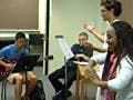 Photo of two students conducting in front of several other student instrumentalists.