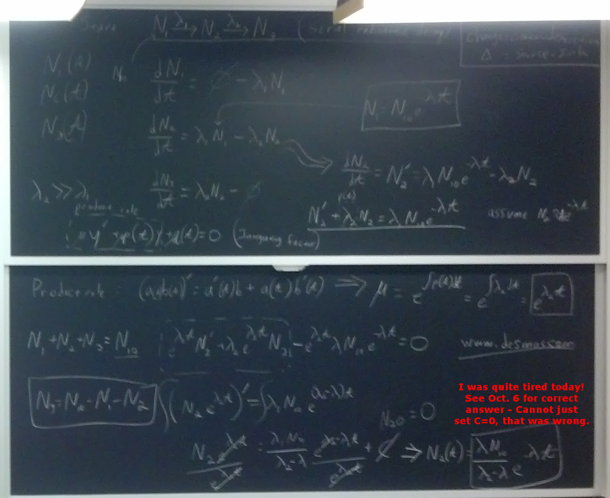 Radioactivity related equations on two blackboards.
