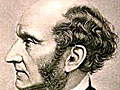 A balding, middle-aged white man with wavy hair, and thick sideburns.