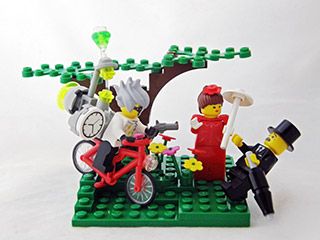 A LEGO® model of a young man on a bike, with a huge clock attached to his back, pointing a gun at an elegantly-dressed older gentleman.