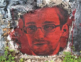 A red-tinted painting of a bespectacled young man with a goatee.