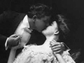 A photo of a couple kissing.