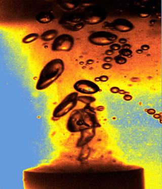 Photo showing gas bubbles form and collapse when a liquid is energized by ultrasound.