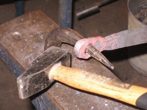 The hole in the workpiece is nearly an inch wide now, with the help of the hardy anvil.