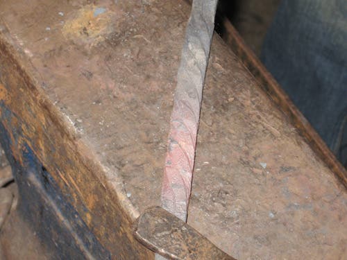 Close-up of the twisted bar, having its corners hammered flat.