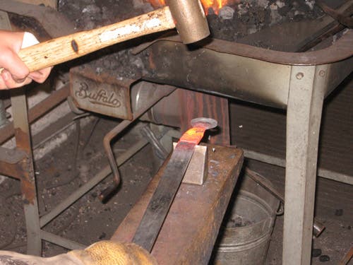After putting a notch in each side for alignment, the piece can be laid flat on the hardy to cut across instead of through.